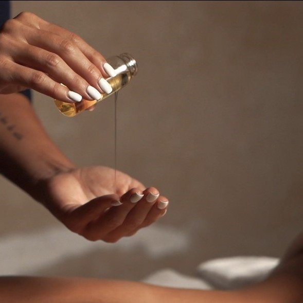 Therapist providing a relaxing spa treatment with essential oils at Spa Empire